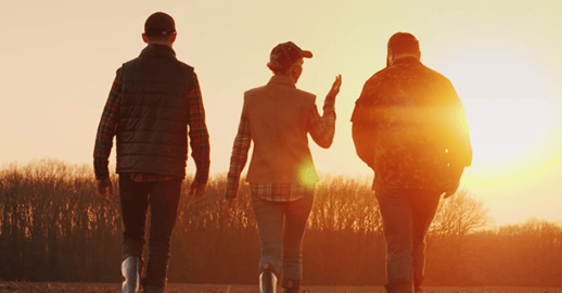 Farmer, community on the land at sunset